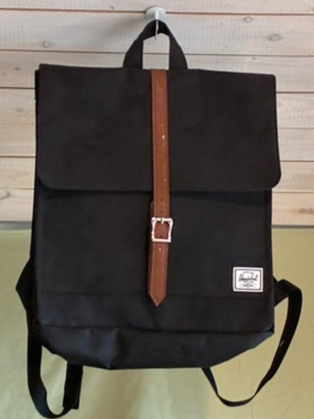 Herschel Backpack in black with leather closure.
